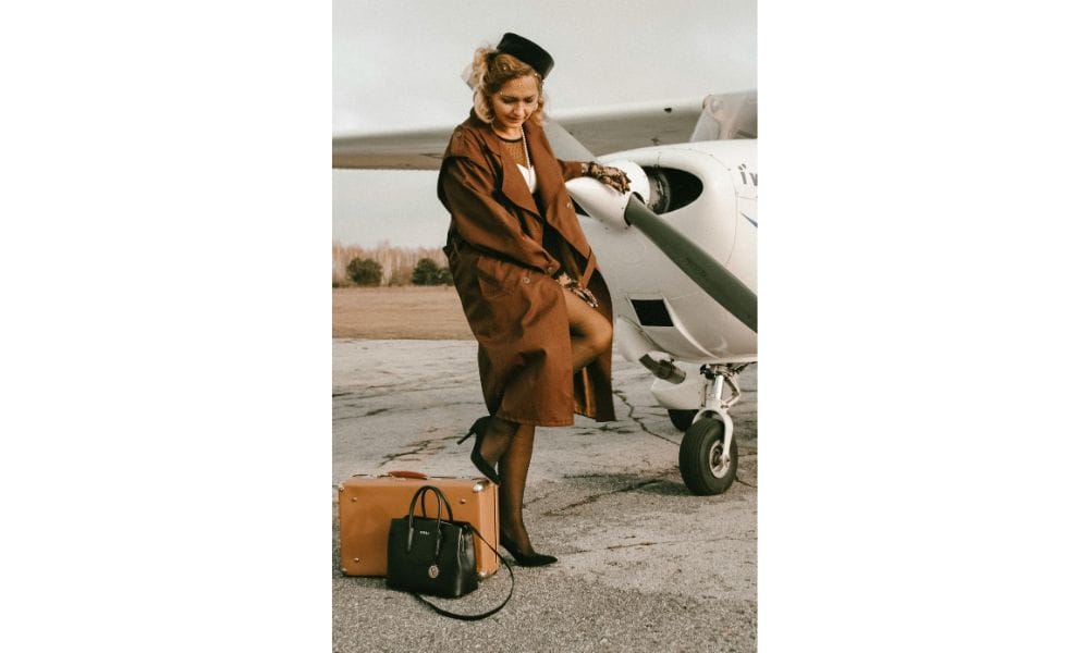 A traveler looking at a suitcase secured with a TSA-approved lock. The person appears thoughtful, checking the lock while standing in an airport