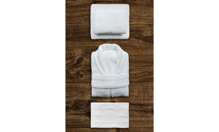 Top view of neatly folded towel and a bathrobe