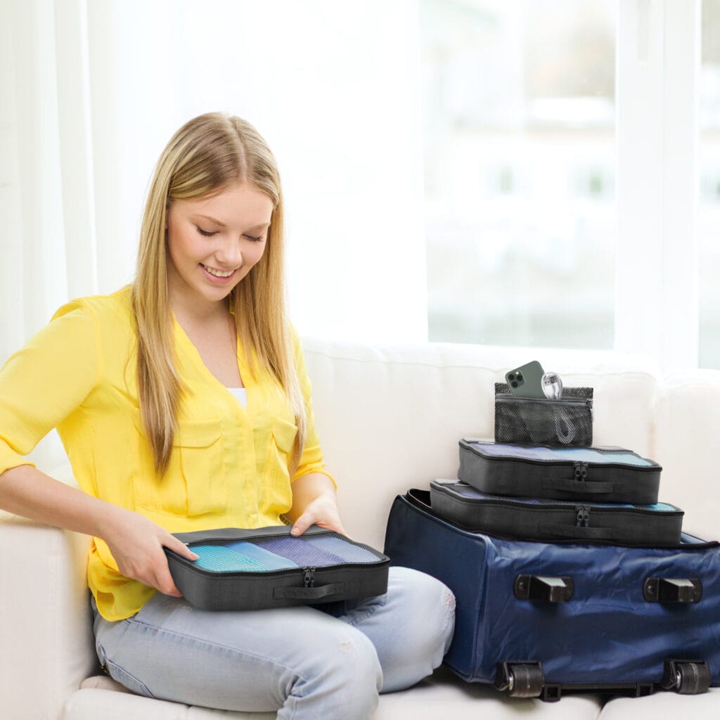A girl sitting down with packing cubes.