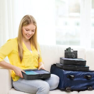 Traveller packing smart with packing cubes to organise suitcase