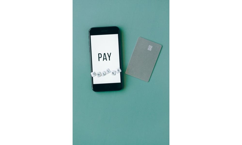 black smartphone on green background