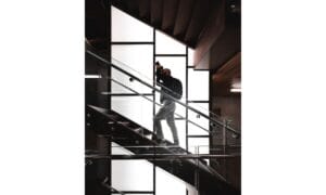 Man Standing on Stairs Holding Camera