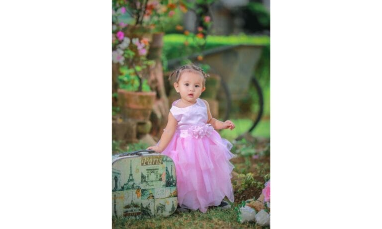 a little girl in a pink dress