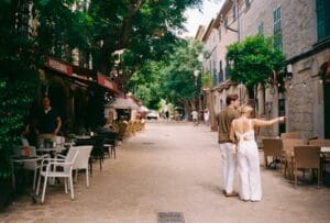 A couple walking down a street in a small town