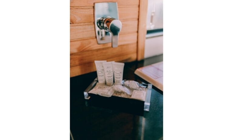 a bathroom with sink toilet and soap