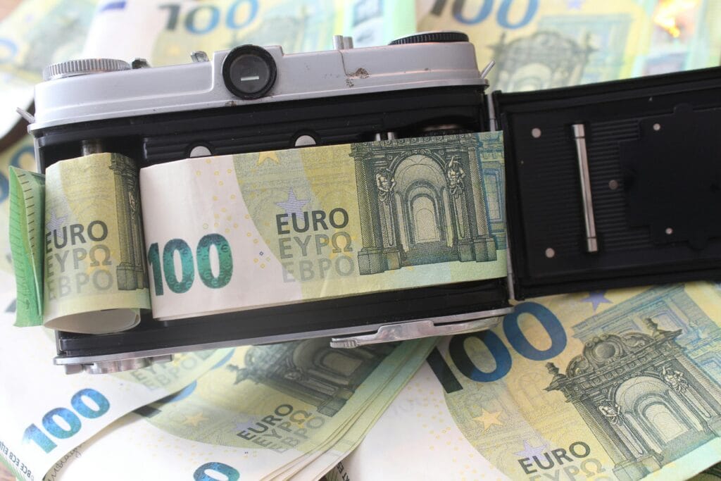Retro camera with 100 euro bills. arry cash and cards safely when travelling