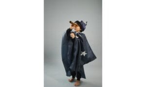 Barefoot boy in astrologer costume looking through spyglass