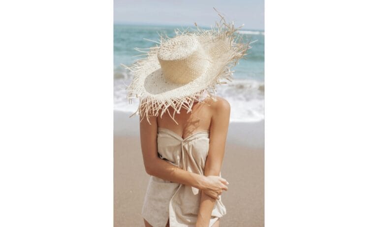 A Woman with a Straw Hat Covering her Face