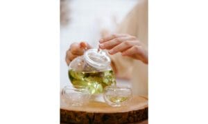 person pouring tea