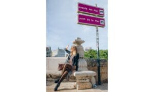 A Woman Wearing a Leather Jacket over a Dress