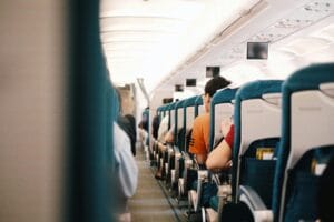 People Sitting on Blue Seats Inside an Airplane