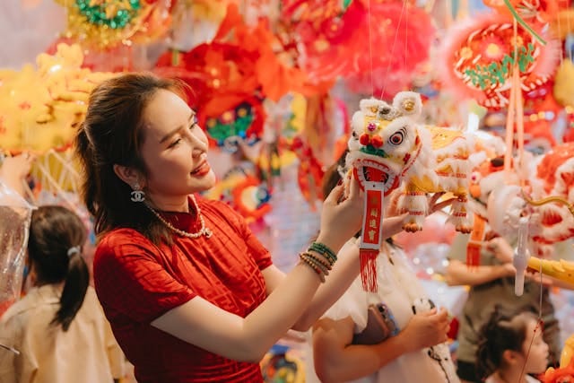 A woman in red holding up a chinese lantern