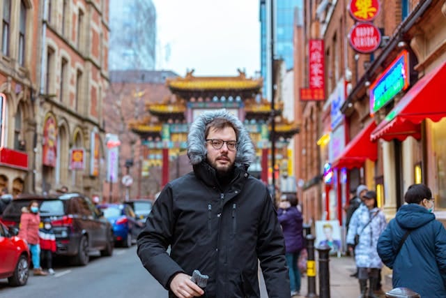 Man in Black Jacket Standing on the Street