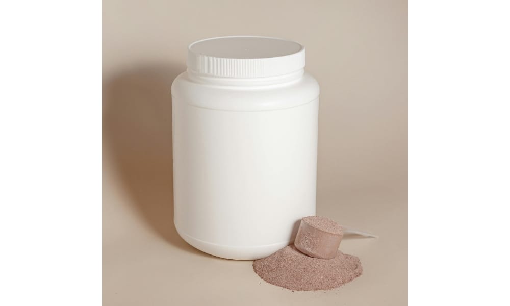 White Plastic Container without a Label and a Pile of Dry Food with a Clear Spoon