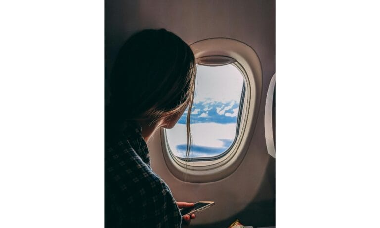 Person Holding Smartphone Riding Airplane