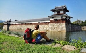 A man with backpack sitting in Hiroshima Japan