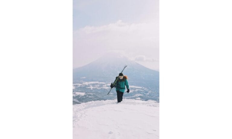 A Woman Walking on Snow Covered Ground
