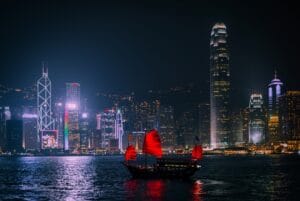 HONG KONG - DECEMBER 8, 2013: Illuminated Chinese red junk (Aqualuna) on Victoria Harbour, Hong Kong, on a foggy Winter night.
