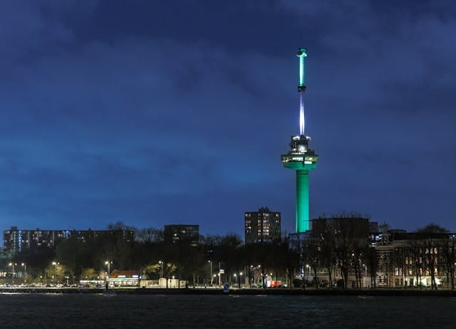 Cityscape of Rotterdam with a Tower by the River in the Evening