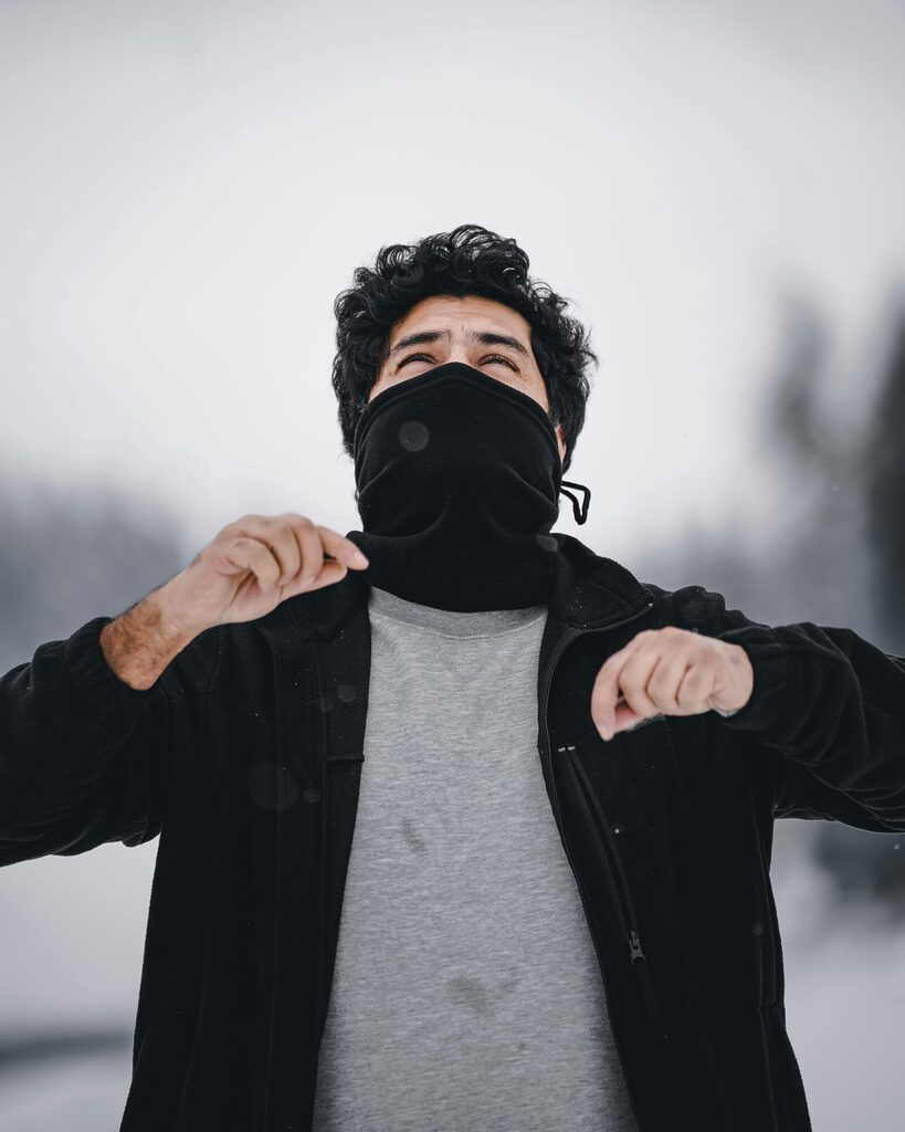 Traveller wearing a snood as a neck warmer in a cool outdoor setting, showing versatile use for warmth and protection