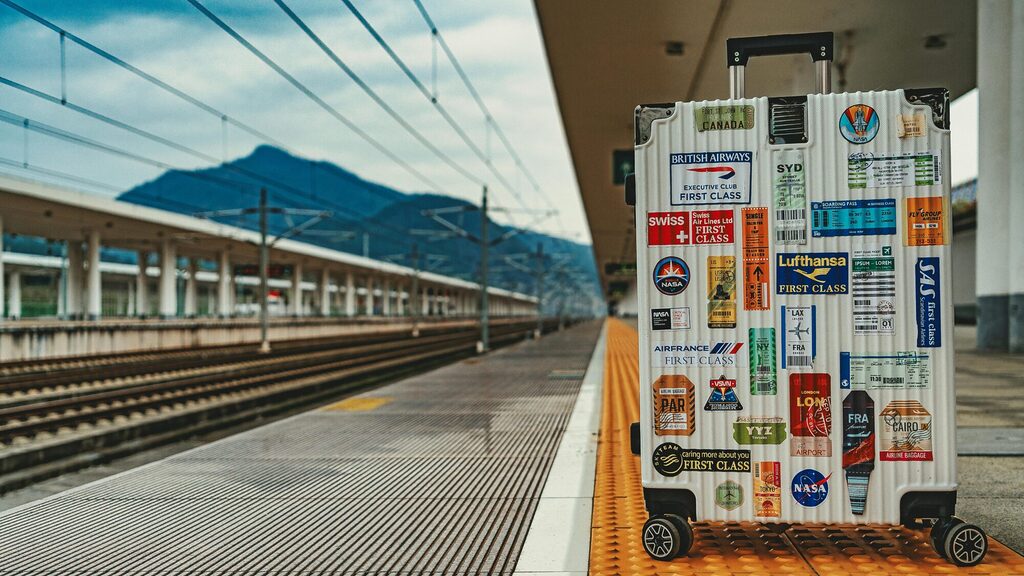 Traveller preparing a suitcase with luggage tag and contact details inside demonstrating simple steps for avoiding lost luggage
