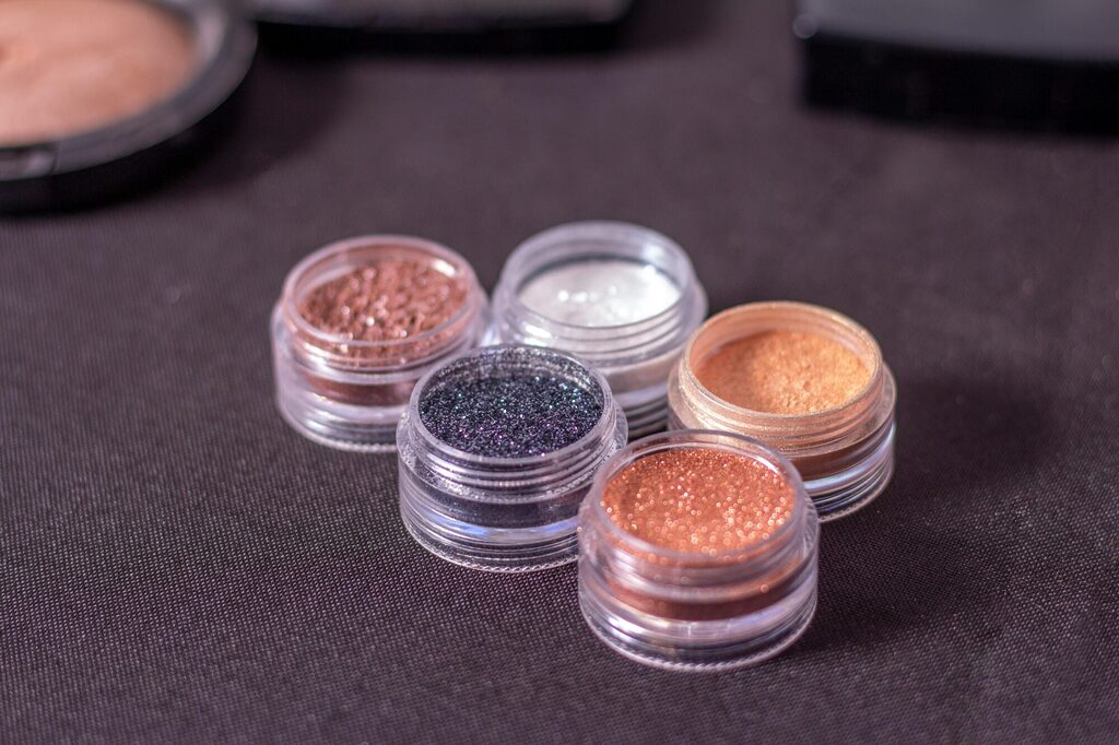 Neatly arranged mini cosmetic containers with creams and serums prepared for organised and compact travel packing