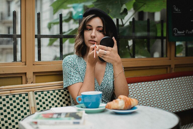 Compact pocket mirror displayed on travel pouch showing foldable casing, slim design and clear reflective surface for everyday grooming