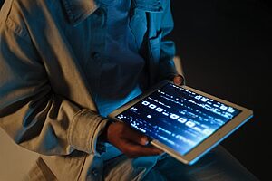 Kid using electronic travel gadgets tablet