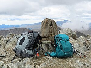 A few hiking backpacks on a rocky mountain.
