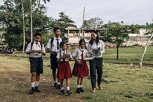 Volunteer teaching children in a rural area