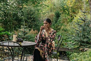 Solo traveller sipping tea in a Japan garden during a healing holiday after divorce