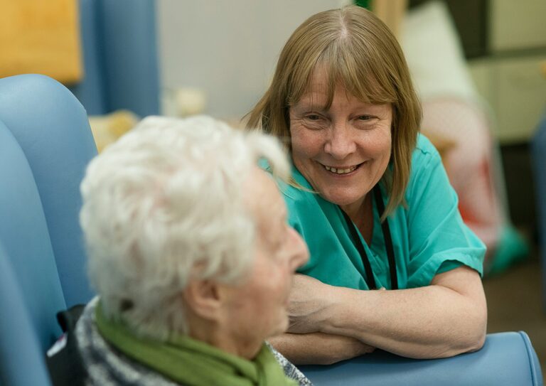 Senior volunteers talking to each other.