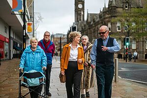Group of senior walking down a city street