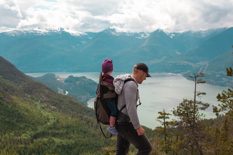 Toddler in a child carrier backpack during a family nature walk