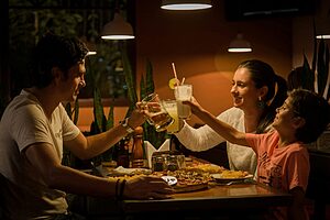 Family sharing a meal at an outdoor restaurant abroad