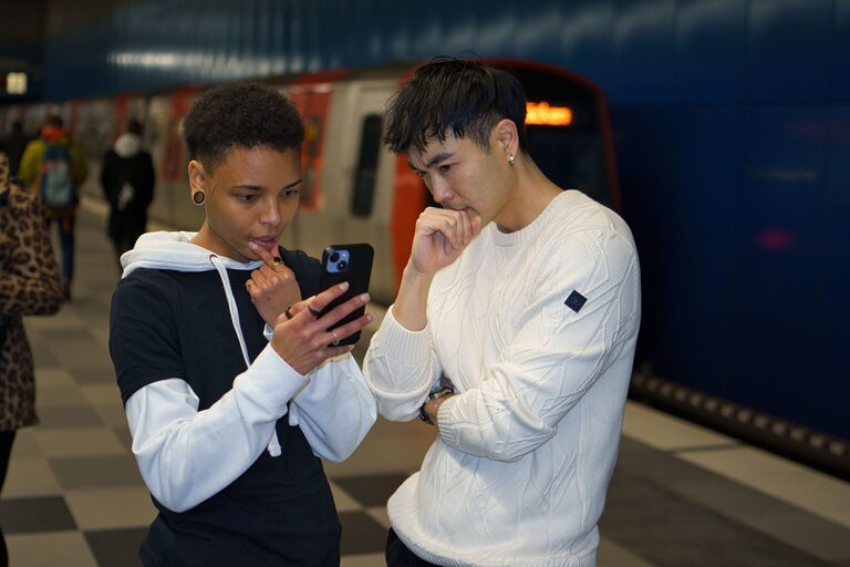 Students checking for a railcard at subway station