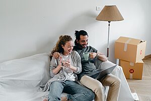 New couple planning their first trip together with a laptop