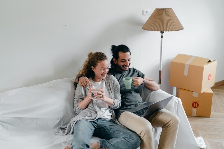 New couple planning their first trip together with a laptop